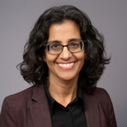 headshot of Kim Nayyer on gray background