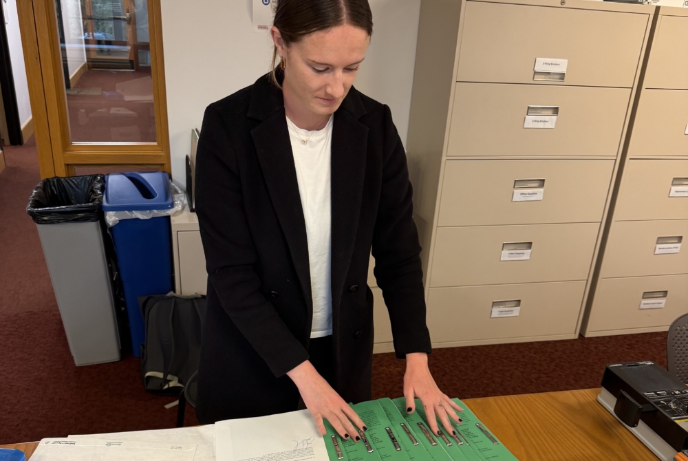 student working with a stack of reports