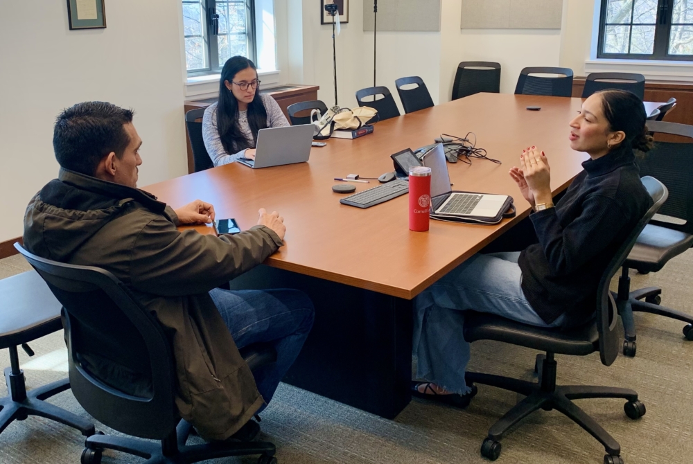 three people sitting at a table